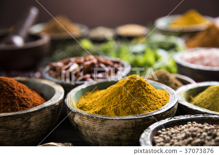 Spices on wooden bowl background Spices on wooden bowl background 37073876