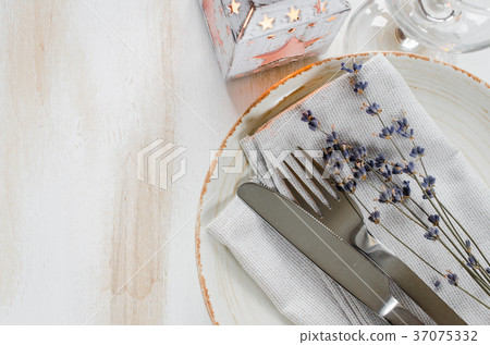 Festive table setting with candles and lavender. Festive table setting with candles and lavender. 37075332
