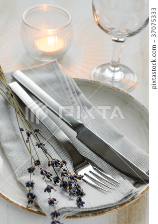 Festive table setting with candles and lavender. Festive table setting with candles and lavender. 37075333