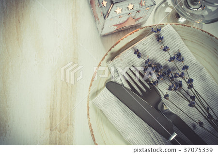 Festive table setting with candles and lavender. 37075339