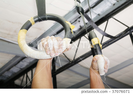Human hanging in Gymnastic Rings.  37076071