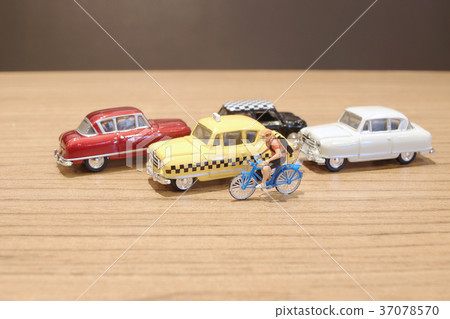 the small figure and toy car and bike the small figure and toy car and bike 37078570