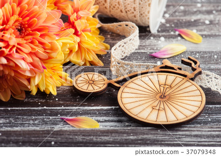 Orange chrysanthemum and wooden bike Orange chrysanthemum and wooden bike 37079348