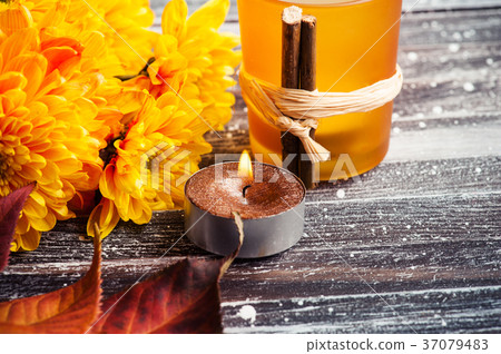 Yellow chrysanthemum, lit golden candles leaves 37079483