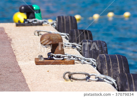 Old metal dock mooring pole with ring and rope for 37079834