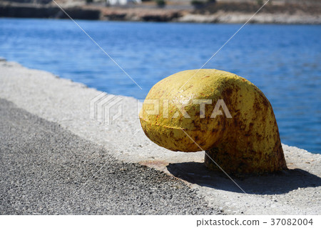 Yellow bollard at harbor 37082004