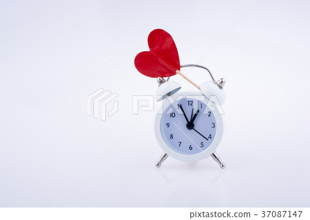 White color alarm clock and red heart shape White color alarm clock and red heart shape 37087147
