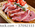 Slices of meat being seasoned for preparation. 37092333