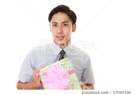 A smiling man with a present A smiling man with a present 37093106
