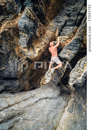 Man climbing up the rock Man climbing up the rock 37093781