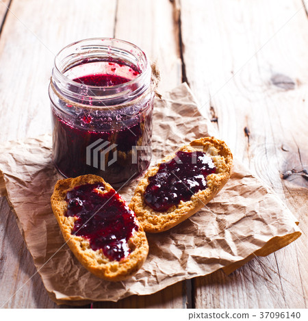 black currant jam in glass jar and crackers black currant jam in glass jar and crackers 37096140