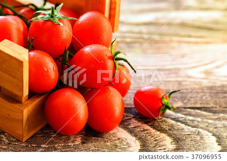 Red ripe tomatoes spill out of box. Rustic view 37096955
