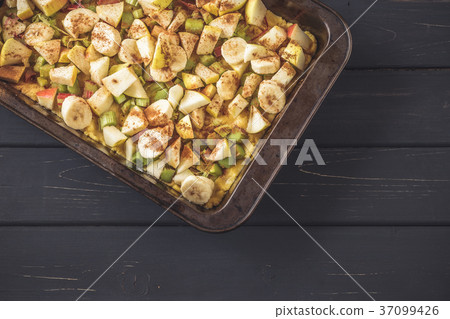 Baking pan with raw dough and cut fruits filling Baking pan with raw dough and cut fruits filling 37099426