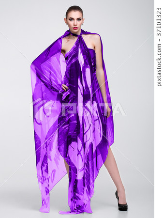 Beautiful girl with violet fashion scarf on grey Beautiful girl with violet fashion scarf on grey 37101323