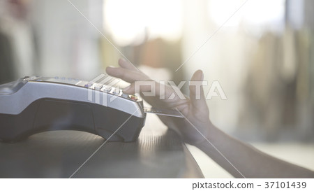 Close up of woman s hand paying with a credit card 37101439