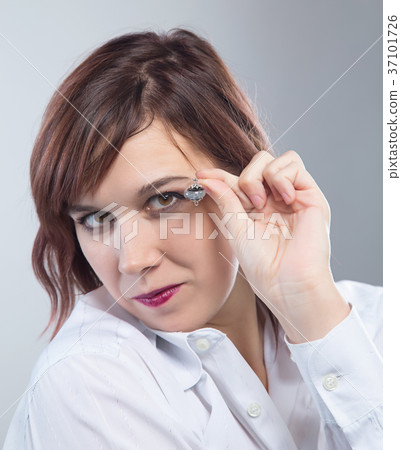 Portrait of woman showing earring Portrait of woman showing earring 37101726