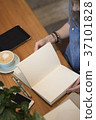 A young girl flips through a clean album. Flat lay 37101828