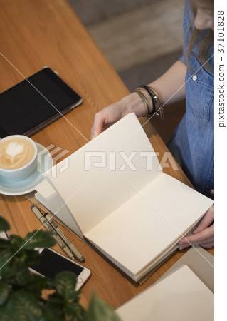 A young girl flips through a clean album. Flat lay A young girl flips through a clean album. Flat lay 37101828