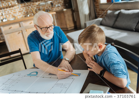 Positive smart boy observing his grandfather 37103761