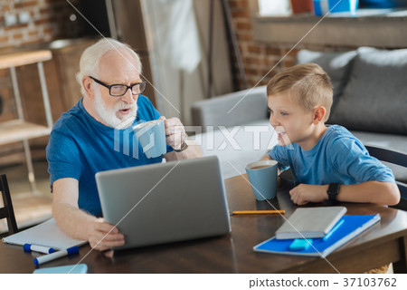 Positive aged man holding a laptop 37103762