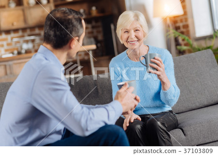 Charming senior woman and her son chatting and Charming senior woman and her son chatting and 37103809