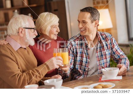 Senior woman watching her son and husband have Senior woman watching her son and husband have 37103947