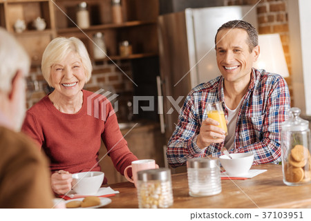 Pleasant family socializing while having breakfast 37103951