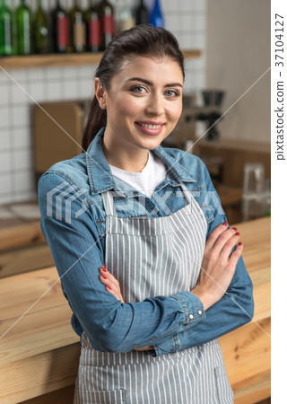 Lovely cheerful waitress standing and waiting for 37104127