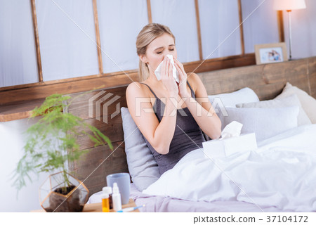 Ill yougn woman resting in bed 37104172