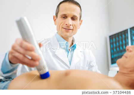 Professional male doctor using medical equipment 37104486
