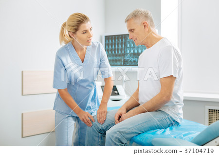 Positive friendly therapist talking to his patient Positive friendly therapist talking to his patient 37104719