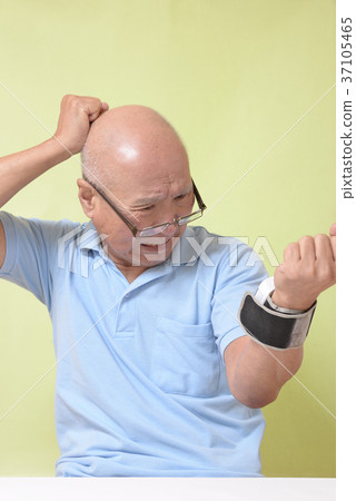 Surprised senior measuring blood pressure Surprised senior measuring blood pressure 37105465