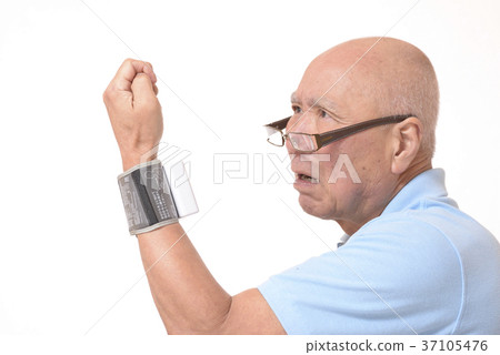 Surprised senior measuring blood pressure Surprised senior measuring blood pressure 37105476