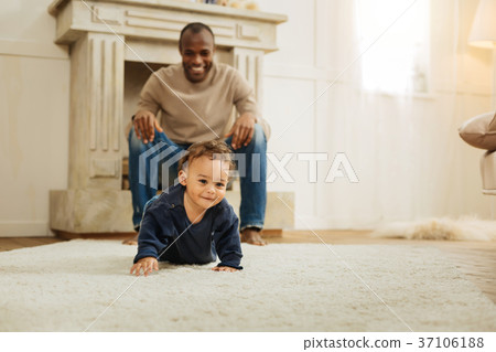 Glad child crawling on the floor 37106188