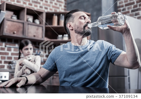 Sad depressed man sitting in the kitchen Sad depressed man sitting in the kitchen 37109134