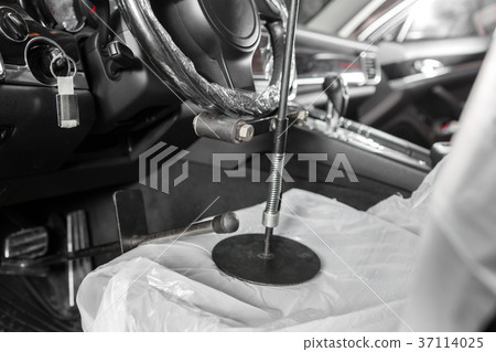 steering wheel lock. auto mechanic sets the car 37114025