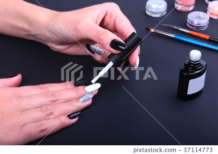 Black, white Nail art manicure. Holiday style Black, white Nail art manicure. Holiday style 37114773