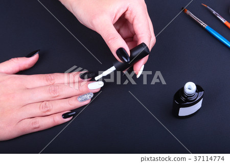 Black, white Nail art manicure. Holiday style Black, white Nail art manicure. Holiday style 37114774