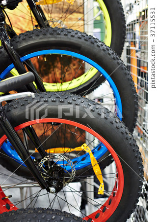 Big tire on wheels of bicycle in shop Big tire on wheels of bicycle in shop 37115531