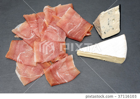 Prosciutto with on gray stone table. Serrano ham Prosciutto with on gray stone table. Serrano ham 37116103