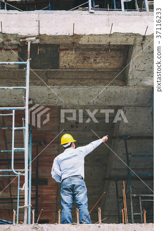Engineer with blueprint in construction site Engineer with blueprint in construction site 37116233