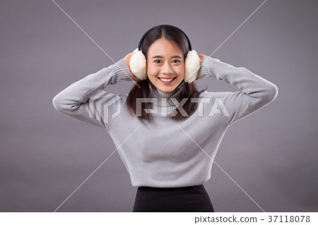 happy smiling asian woman with earmuffs 37118078