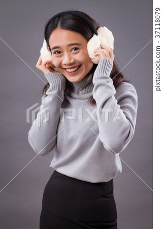 happy smiling asian woman with earmuffs 37118079