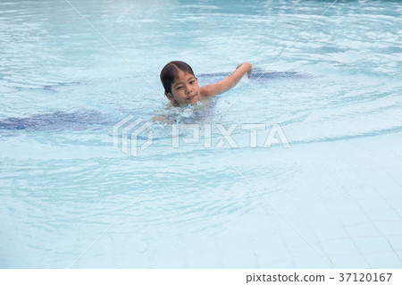 8 years old Asian kid swimming in swimming pool 8 years old Asian kid swimming in swimming pool 37120167