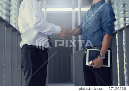 Business people shaking hands Business people shaking hands 37120286
