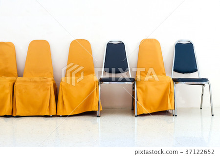 A row of yellow chairs and blue chair in row. A row of yellow chairs and blue chair in row. 37122652