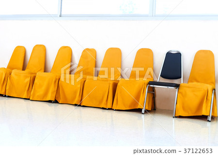 A row of yellow chairs and blue chair in row. A row of yellow chairs and blue chair in row. 37122653