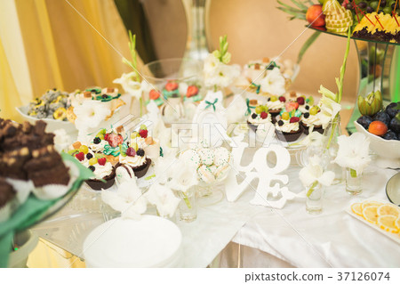 Different kinds of baked sweets on a buffet Different kinds of baked sweets on a buffet 37126074