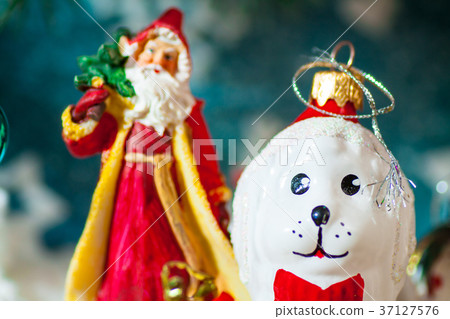 a toy dog in Santa hat and Christmas gifts on the a toy dog in Santa hat and Christmas gifts on the 37127576