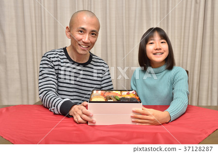 Parents and children eating new year dishes Parents and children eating new year dishes 37128287